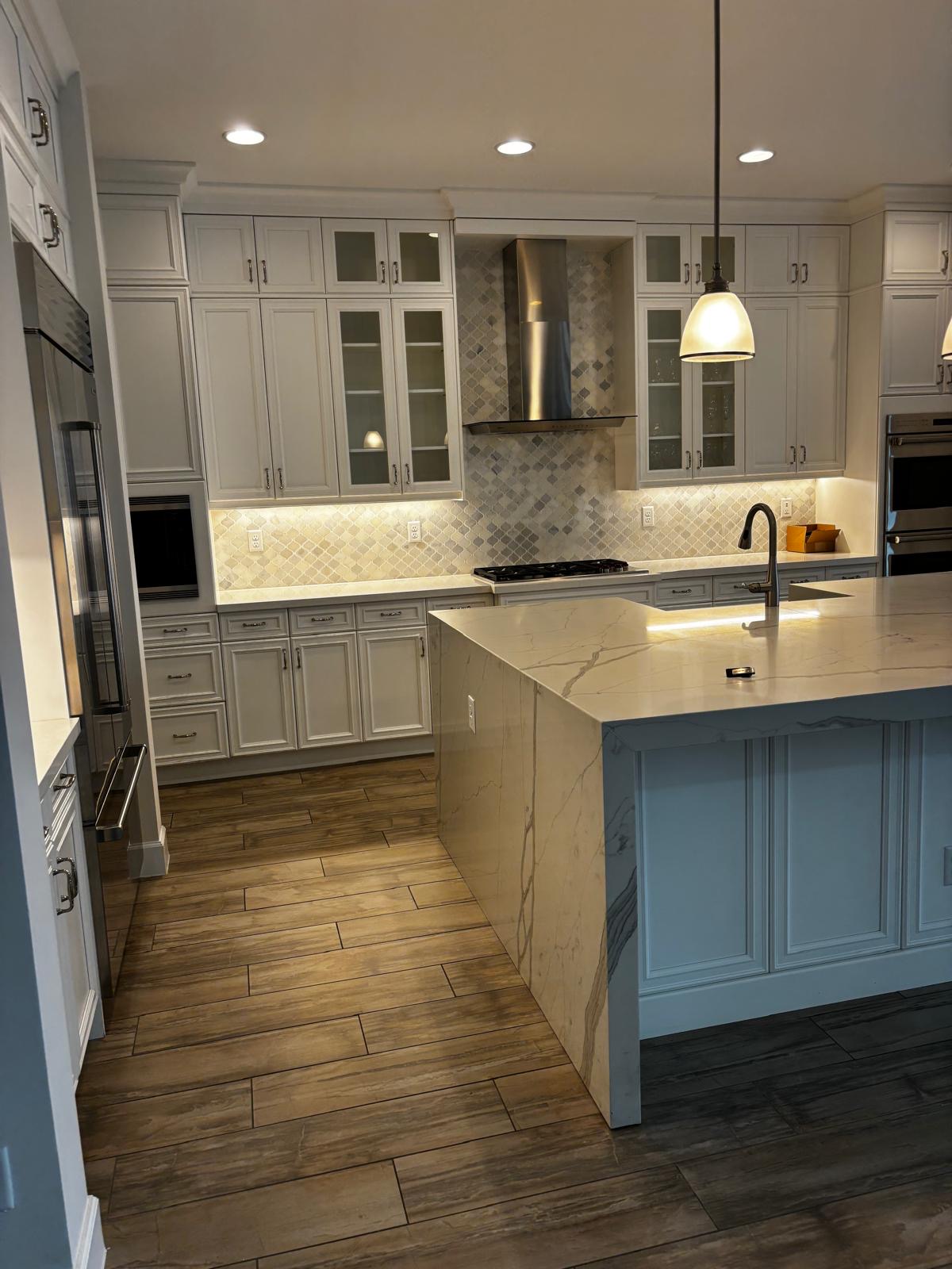 High-end St. Louis kitchen with marble waterfall island after cleaning